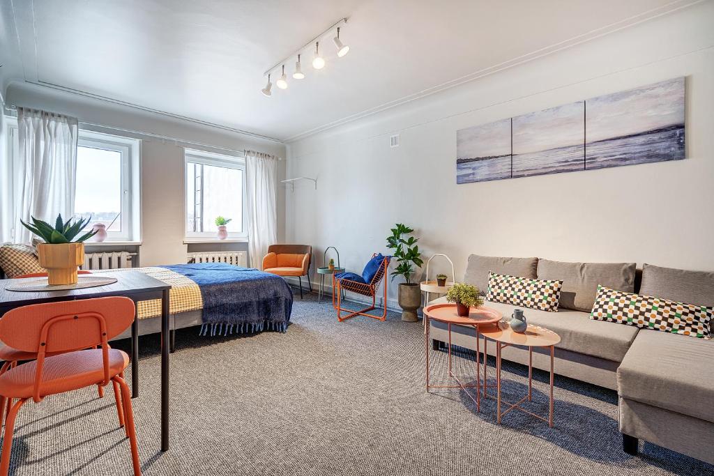 a living room with a couch and a table at Funky Penthouse City Center in Kaunas