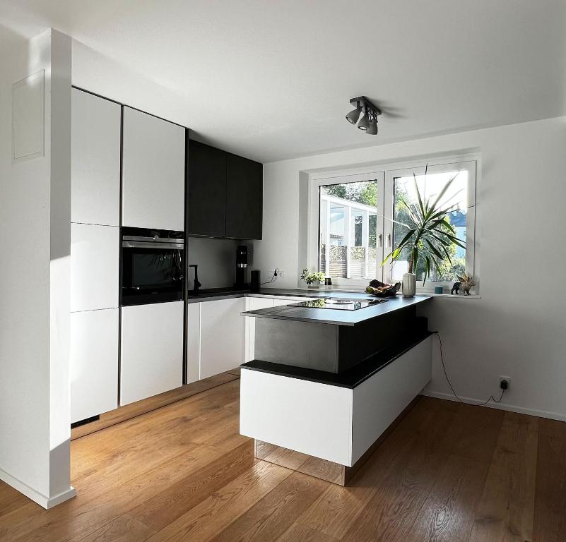 a kitchen with white cabinets and a sink in it at Helle Wohnung in Top Lage! in Linz