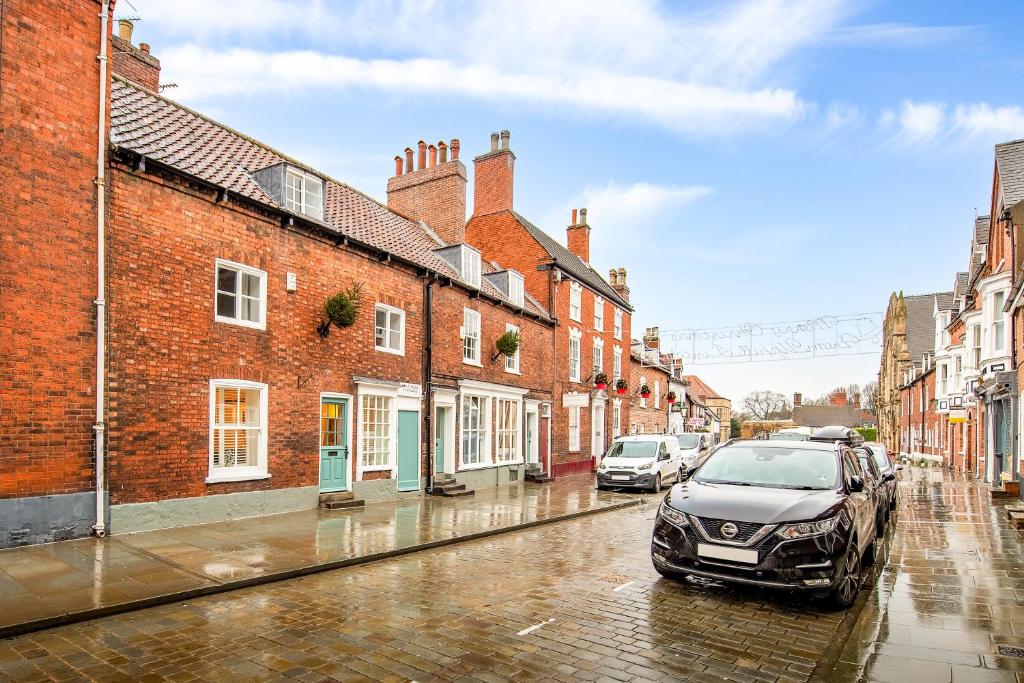 a car parked on a wet street next to buildings at 31 Bailgate Lincoln in Lincolnshire