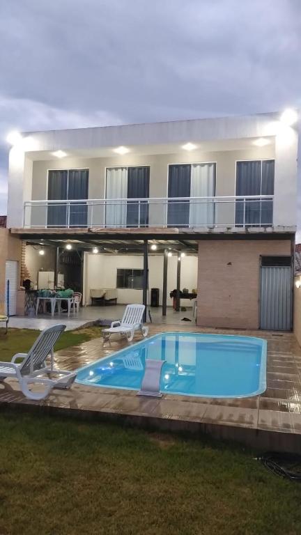 a house with a swimming pool in front of it at espaço 16 in Maricá