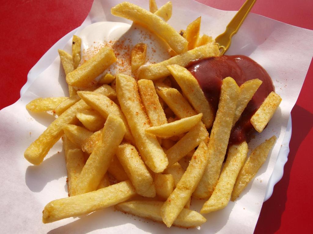 a plate of french fries and a hot dog at npqrs in Bangalore