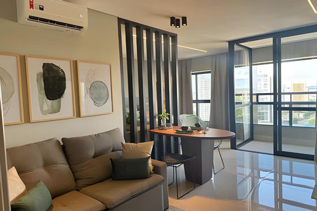 a living room with a couch and a table at Vertigo 243 - Gestão FGibran. in Campo Grande