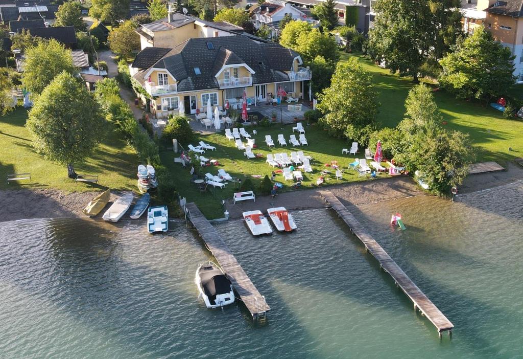 an aerial view of a house with a dock in the water at Seevilla Wochinz in Faak am See