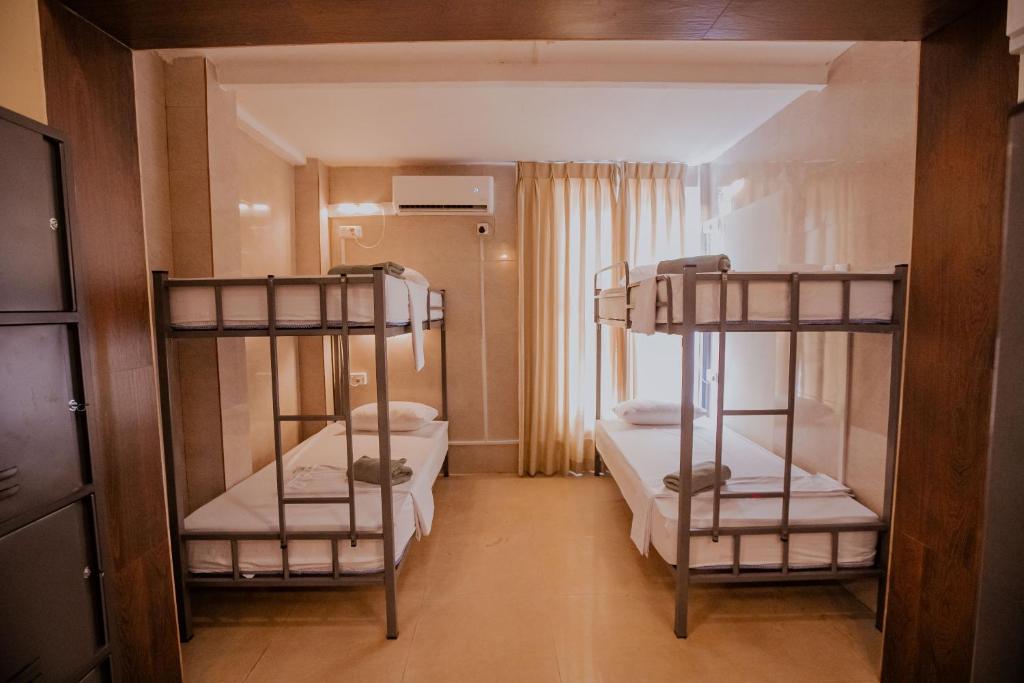 Postel nebo postele na pokoji v ubytování Drop Inn Hostels