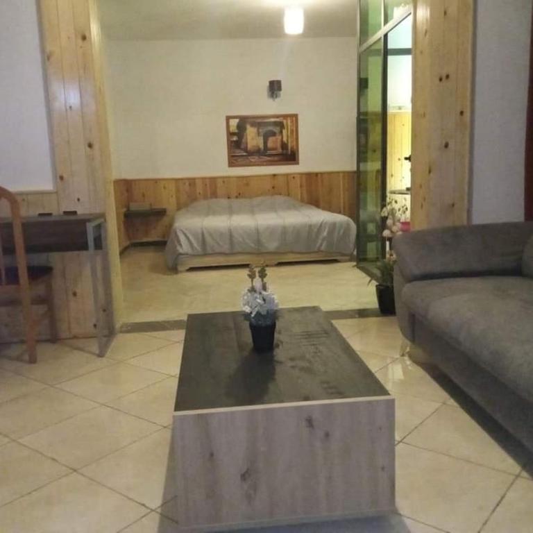 a living room with a couch and a bed at فندق صنهاجة صفرو 
