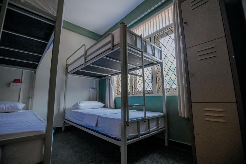 Postel nebo postele na pokoji v ubytování Drop Inn Hostels