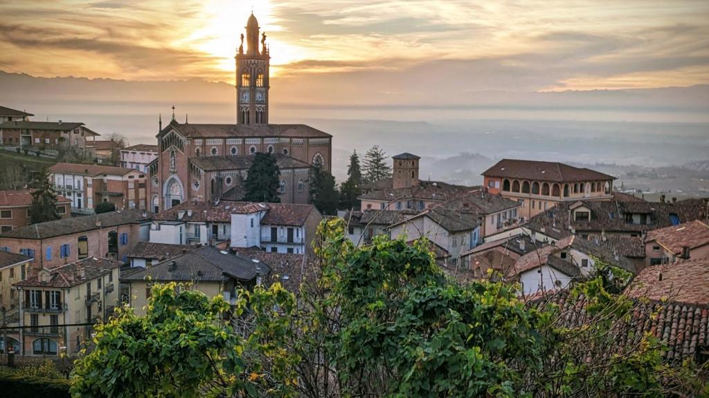 a view of a city with a clock tower at Charming Barolo Wine Loft in Monforte dʼAlba