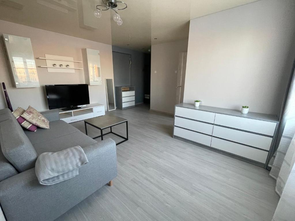 a living room with a couch and a flat screen tv at Vironia Apart in Kohtla-Järve