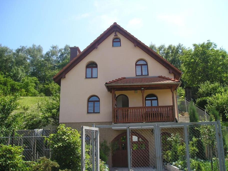 a house with a balcony on top of it at Chalupa Ohře in Libochovice