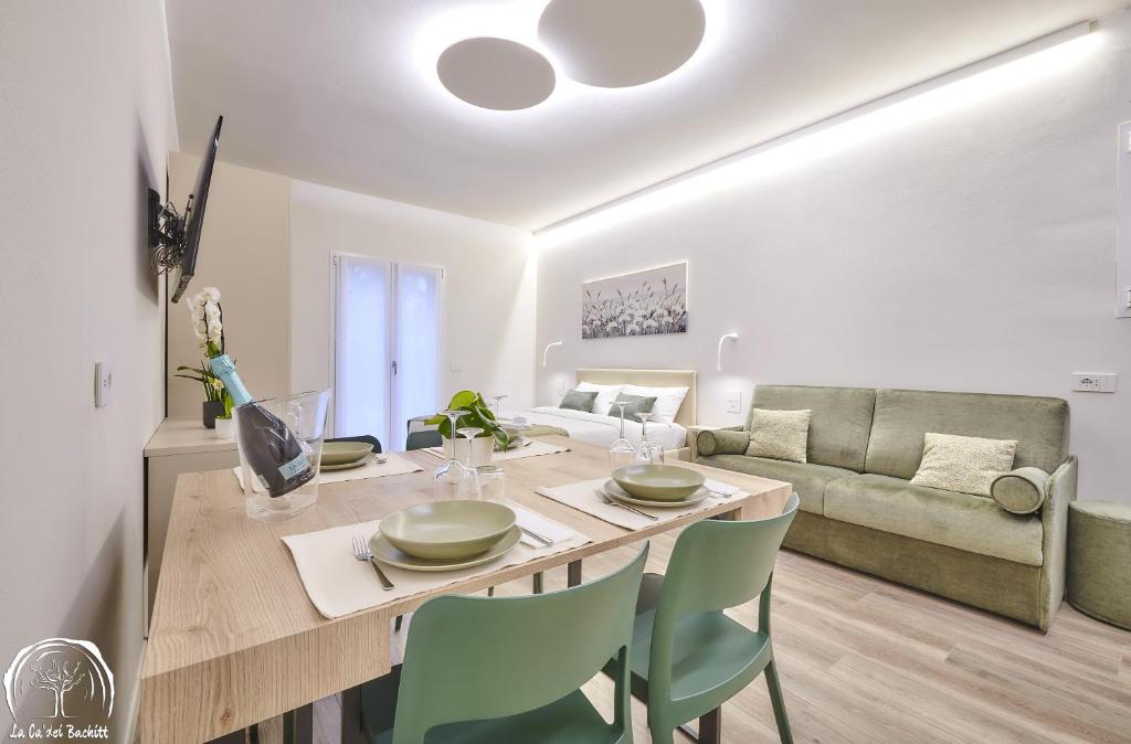 een eetkamer en een woonkamer met een tafel en stoelen bij FORESTERIA GUESTHOUSE CA' DEI BACHITT in Lierna