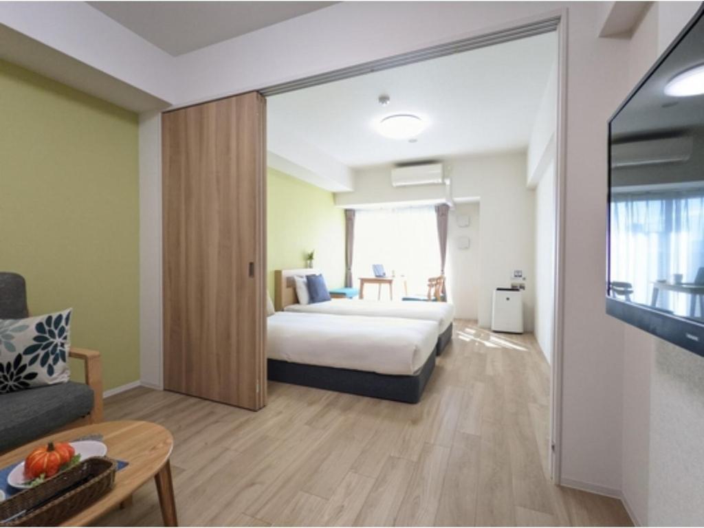 a hotel room with a bed and a tv at Eslead Hotel Namba South III - Vacation STAY 37784v in Osaka