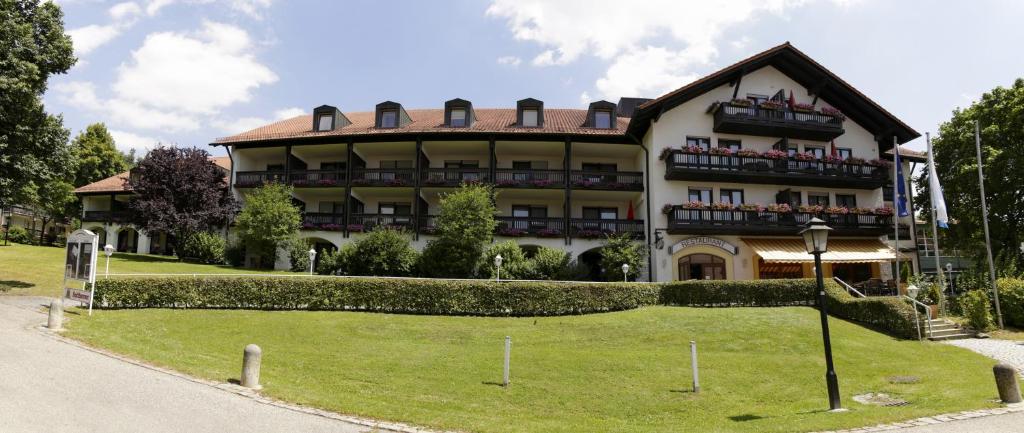 a large building with a lawn in front of it at Hotel Birkenhof Therme in Bad Griesbach