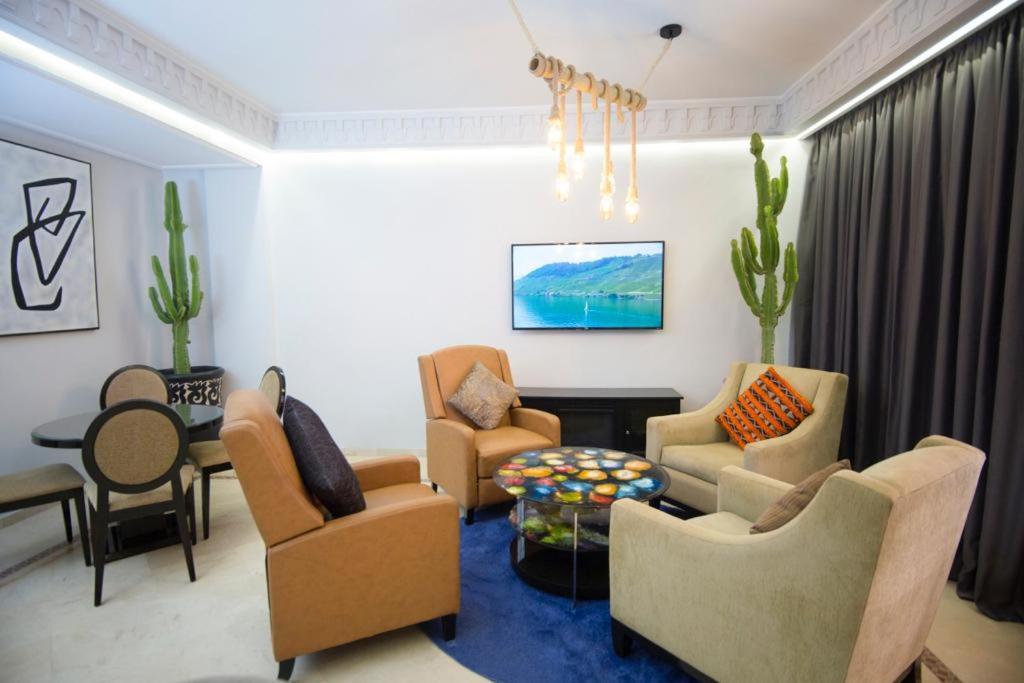 a living room with couches and chairs and a table at Luxe apartment / Prime location / 2 bedr- 2.5 bathrooms in Marrakech