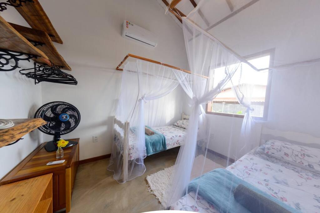 Postel nebo postele na pokoji v ubytování Aconchego em Cumuru - Casa Cafuné