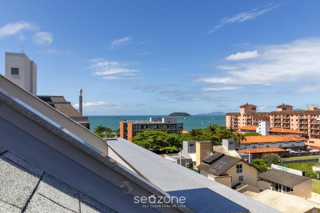 a view of a city from the roof of a building at MOR - Apartamentos a 230m da Praia de Jurerê Floripa/SC in Florianópolis