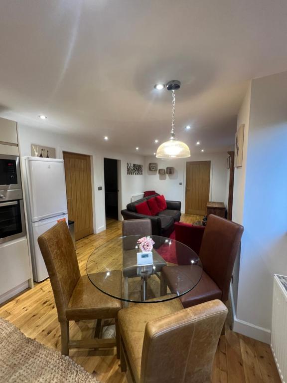 a living room with a table and a couch at Pine cottage with private hot tub in Upper Hulme