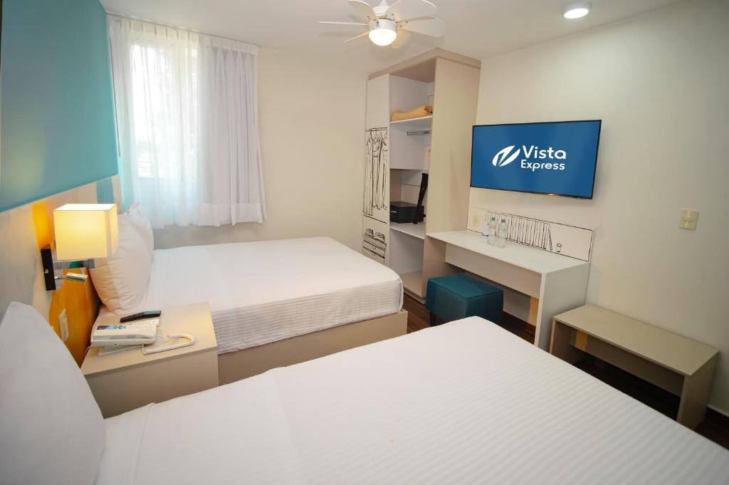Postel nebo postele na pokoji v ubytování Vista Express Guadalajara Expo SureStay Collection by BW