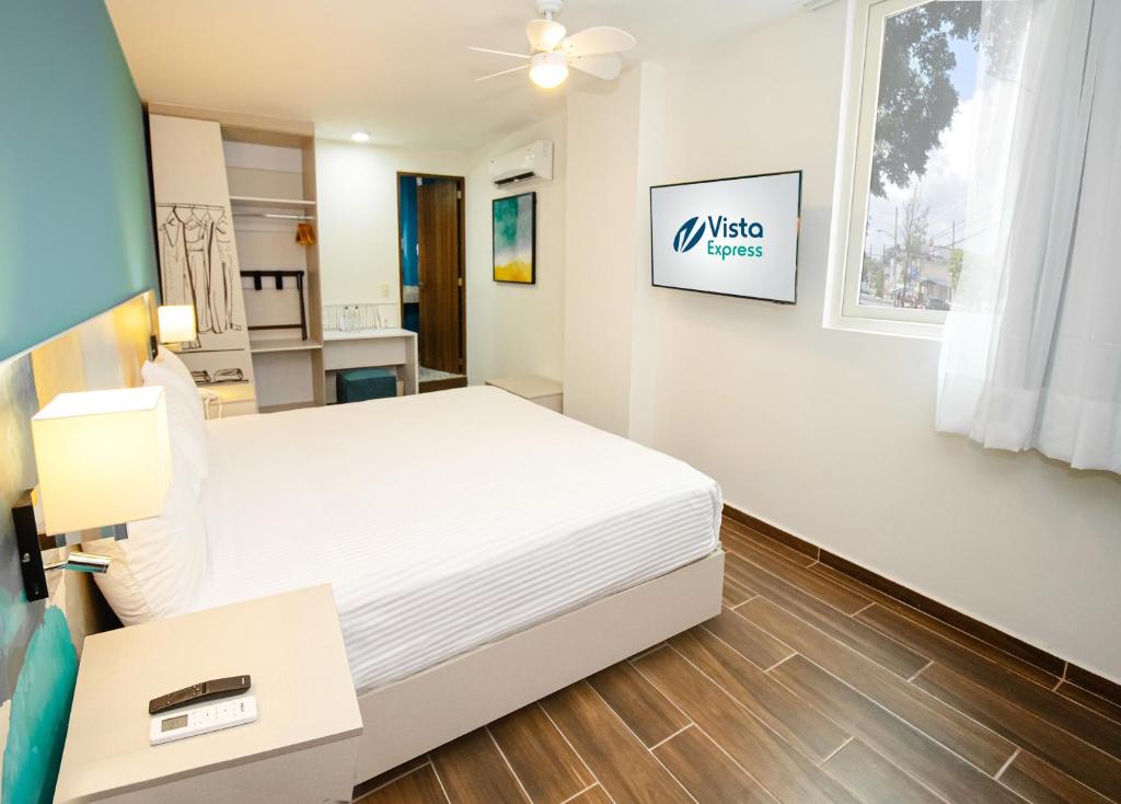 A bed or beds in a room at Vista Express Guadalajara Expo