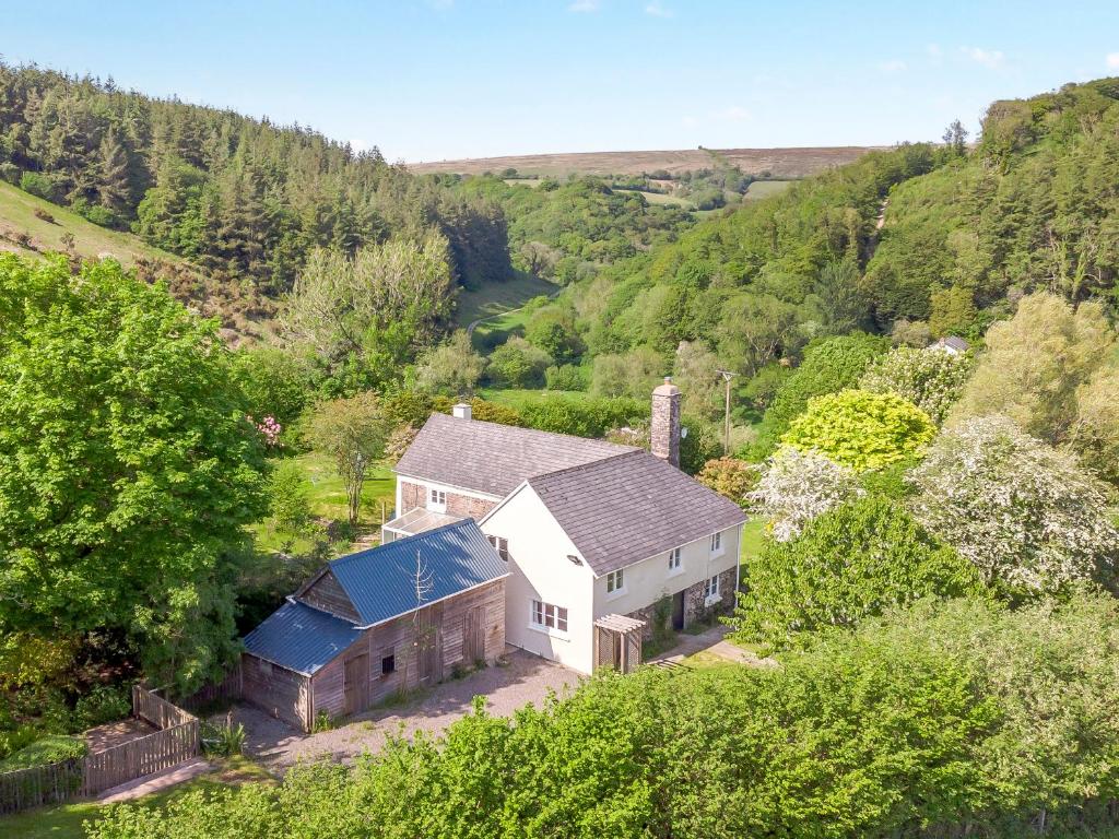 an aerial view of a house in the hills at Whitley Farm in South Molton