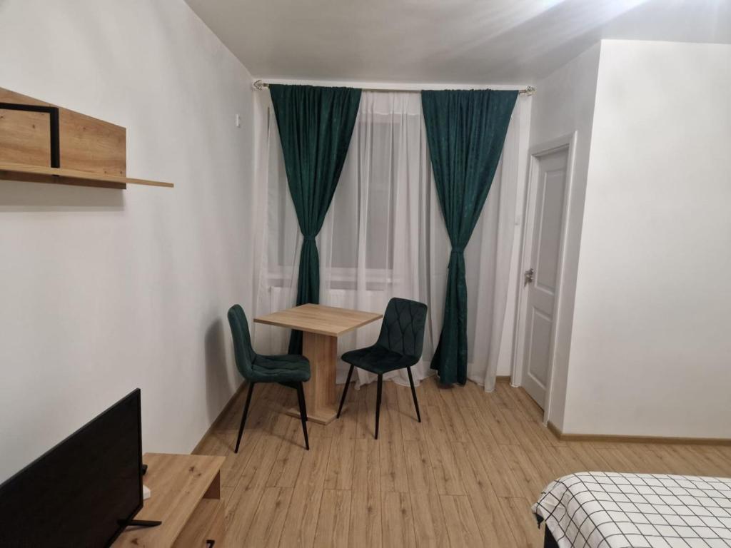 a room with a table and two chairs and a window at The Nest in Brăila