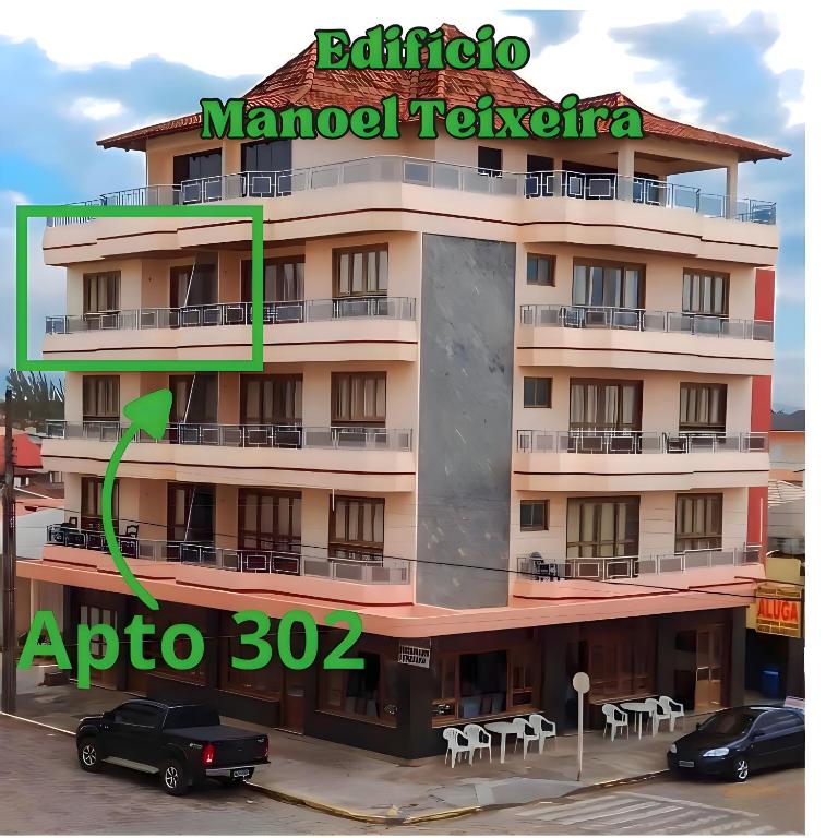 a building with a sign for a hotel at Apto 302 Edifício Manoel Teixeira in Arroio do Silva