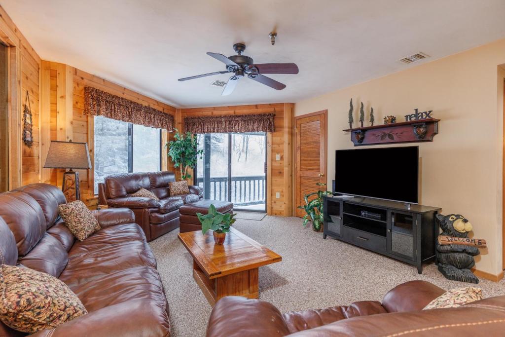a living room with leather furniture and a flat screen tv at Seven Springs Stoneridge 3 Bedroom Standard Condo, Private Deck condo in Champion