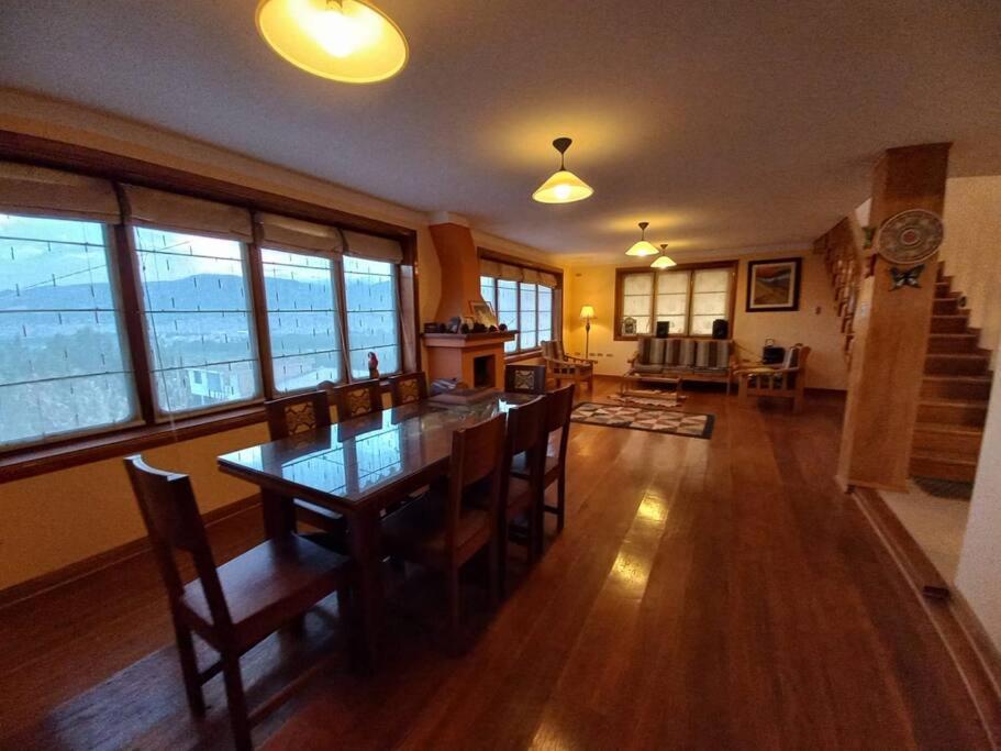 a living room with a table and chairs in a house at La Loma in Cajamarca