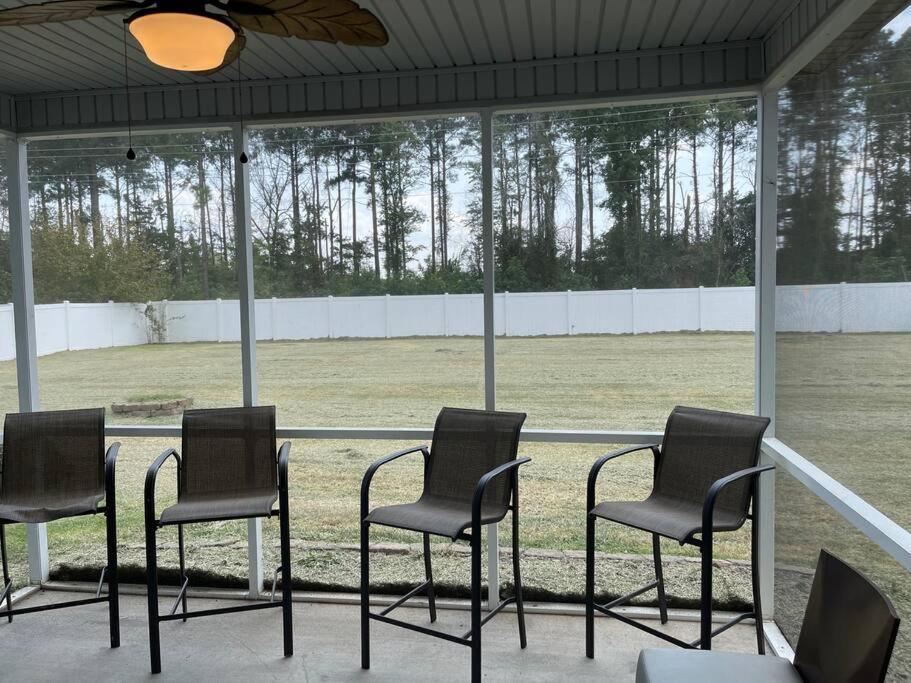 a group of chairs sitting in front of a field at Spacious Home Near Shaw in Sumter