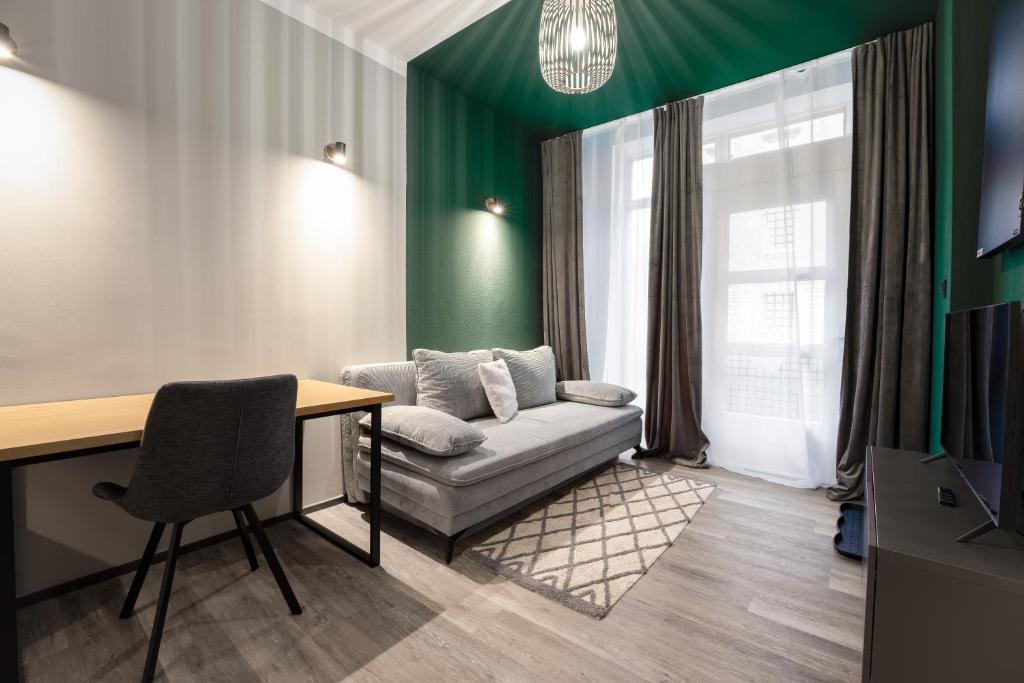 a living room with a couch and a table at 3-Zimmer-Apartment in einer ruhigen Seitenstraße im Nürnberg Nord in Nuremberg