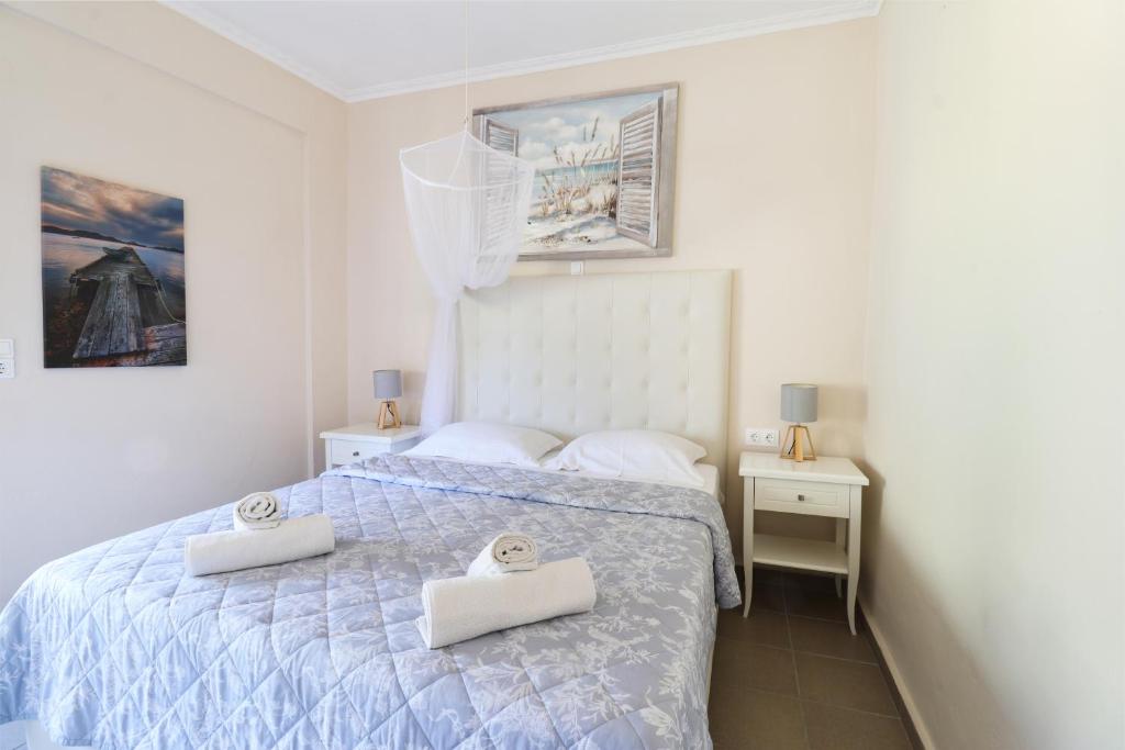 Postel nebo postele na pokoji v ubytování Louiza Apartments