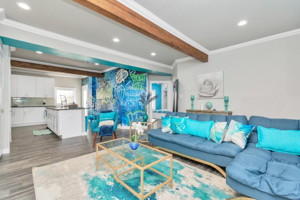 ein Wohnzimmer mit einem blauen Sofa und einem Tisch in der Unterkunft Prolific Blue Oasis near Med Ctr Dwntwn Galleria in Houston