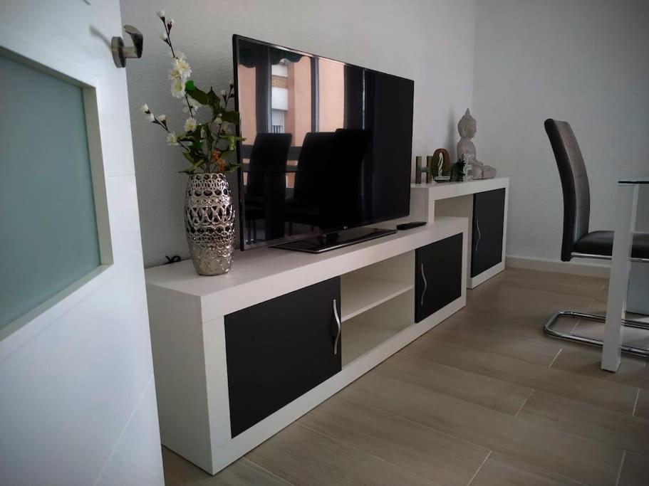 a living room with a flat screen tv on a wall at Apartamento Medina cerca de la Ribera in Córdoba