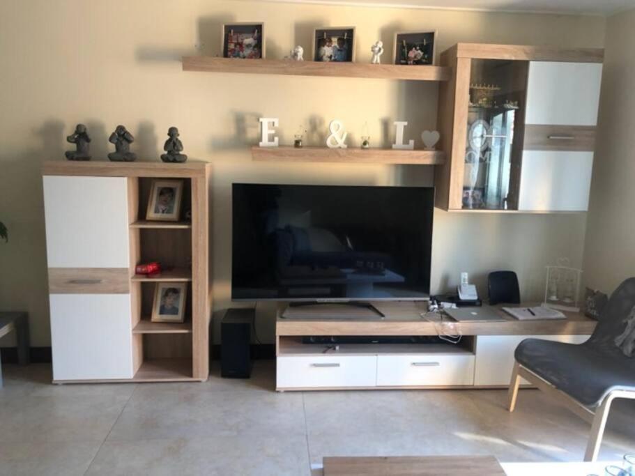 uma sala de estar com um grande centro de entretenimento com uma grande televisão em MAISON DE FAMILLE À 20 MN DE LISBONNE ET SETÚBAL em Quinta do Conde