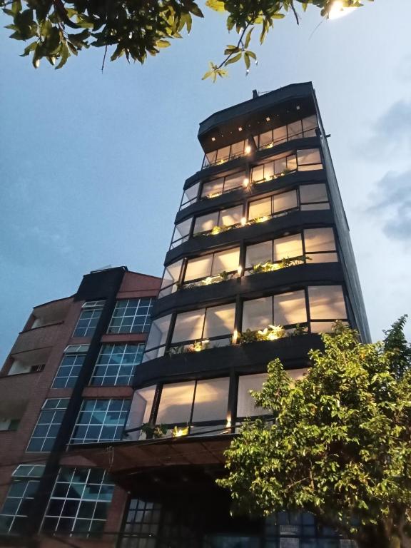 a tall building with lights in the windows at perla del norte in Bello