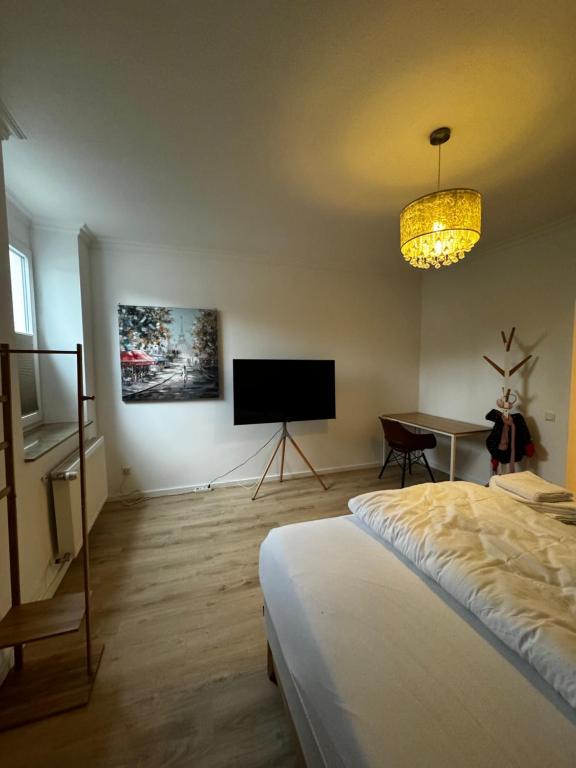 a bedroom with a bed and a flat screen tv at Paris bei Düsseldorf in Hilden