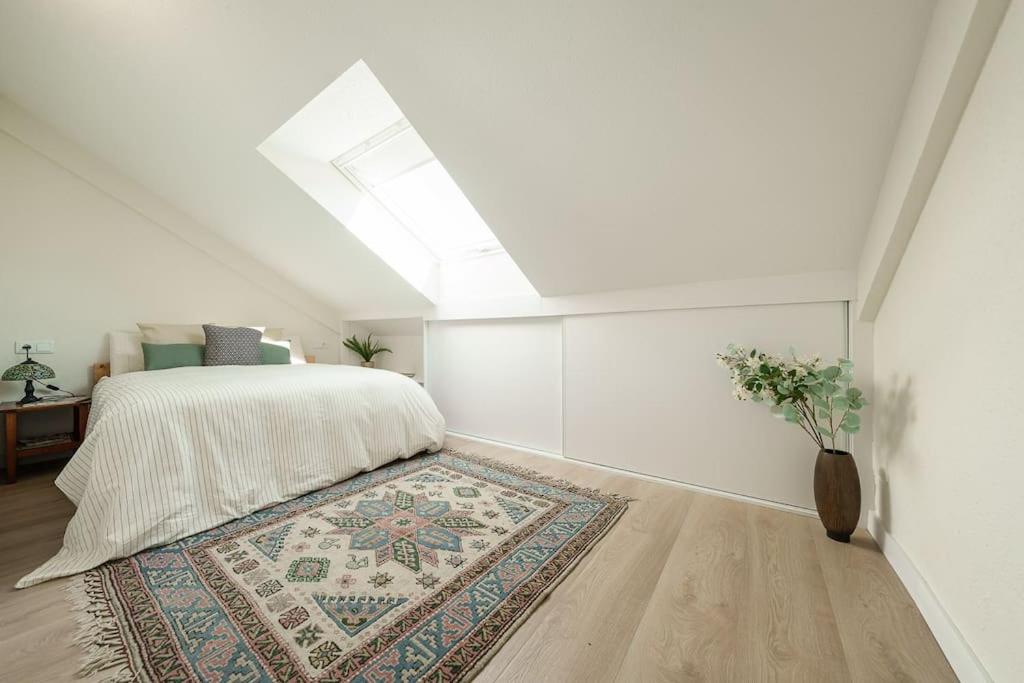 a bedroom with a bed and a vase with a rug at El Ventanal de Collarada in Villanúa