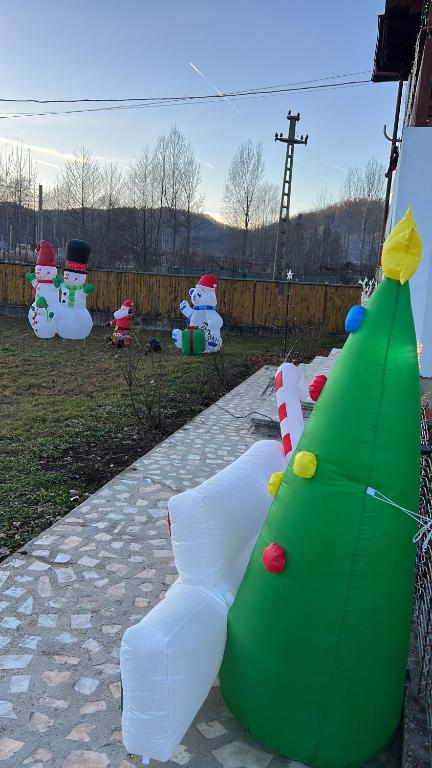 a green and white christmas tree and other decorations at Poama villa in Negruleşti