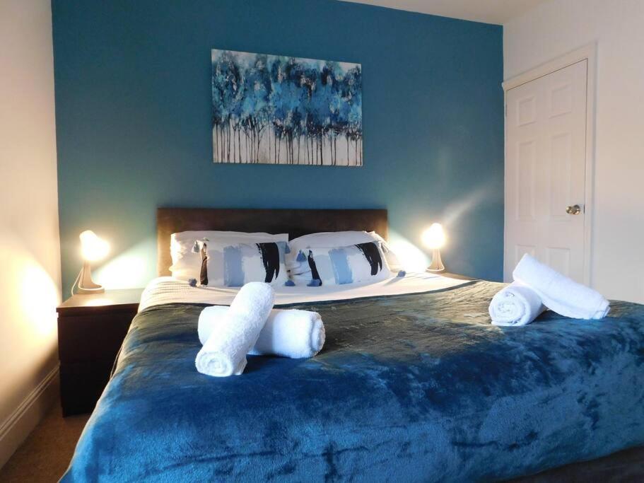 a bedroom with a large bed with two white pillows at Lorne Lodge Central Swindon in Swindon