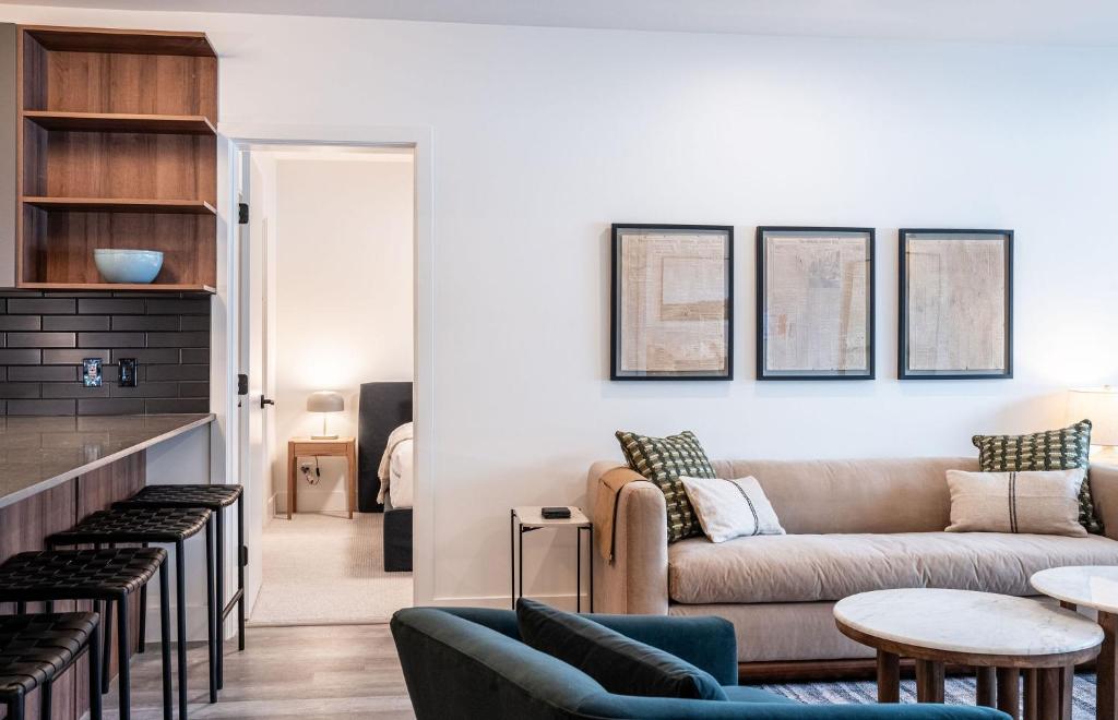 a living room with a couch and a table at Escape to Revy - Beautifully Designed Condo in Revelstoke