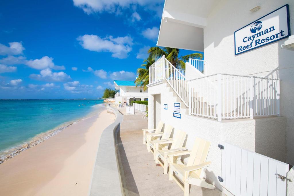a hotel on the beach with a view of the ocean at Cayman Reef Resort #52 in George Town