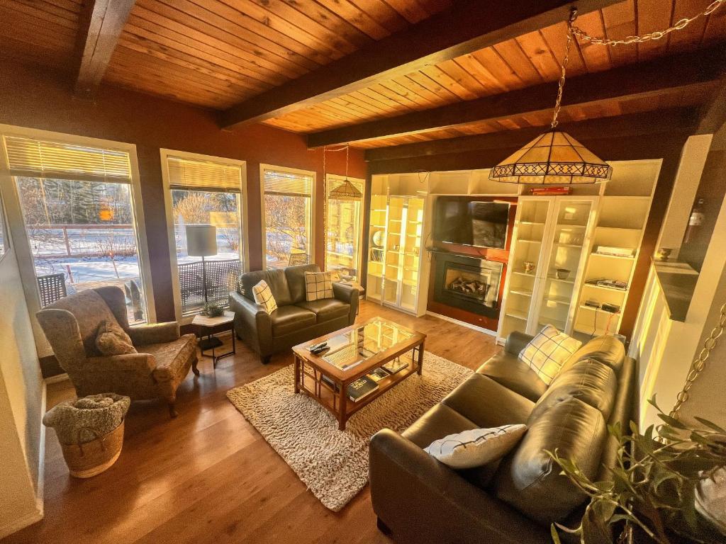 a living room with couches and a fireplace at Whitehorse Home on the River in Whitehorse