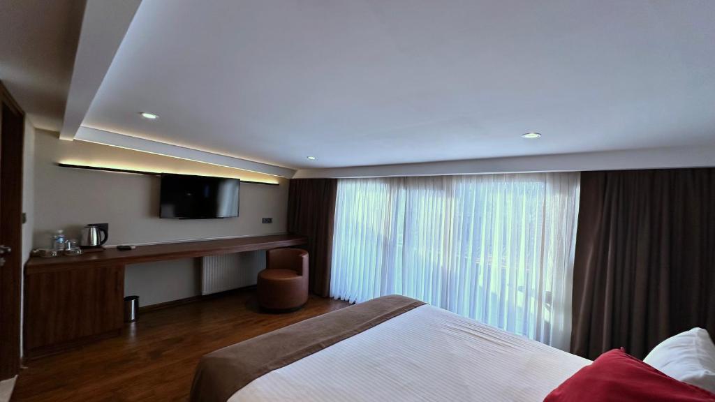 Postel nebo postele na pokoji v ubytování Snog Rooms & Suites