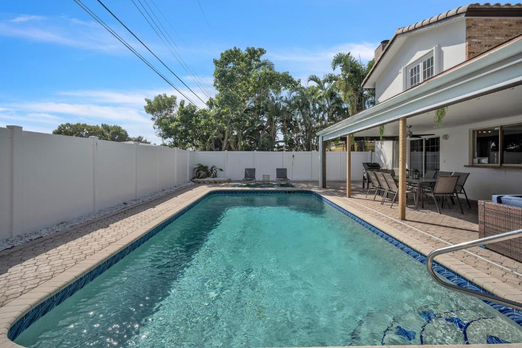 a swimming pool in the backyard of a house at Lauderdale By The Sea home in Fort Lauderdale