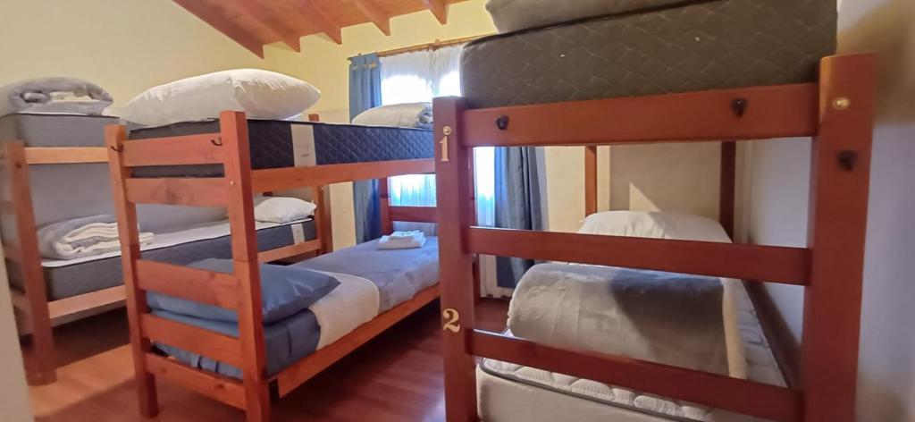 a couple of bunk beds in a room at Casa céntrica compartida in Ushuaia