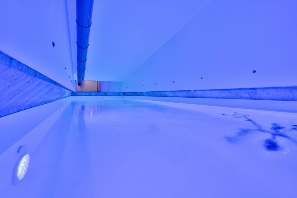 a bath tub filled with water with a blue light at Appart avec parking et piscine proche Vieux-Port in Marseille