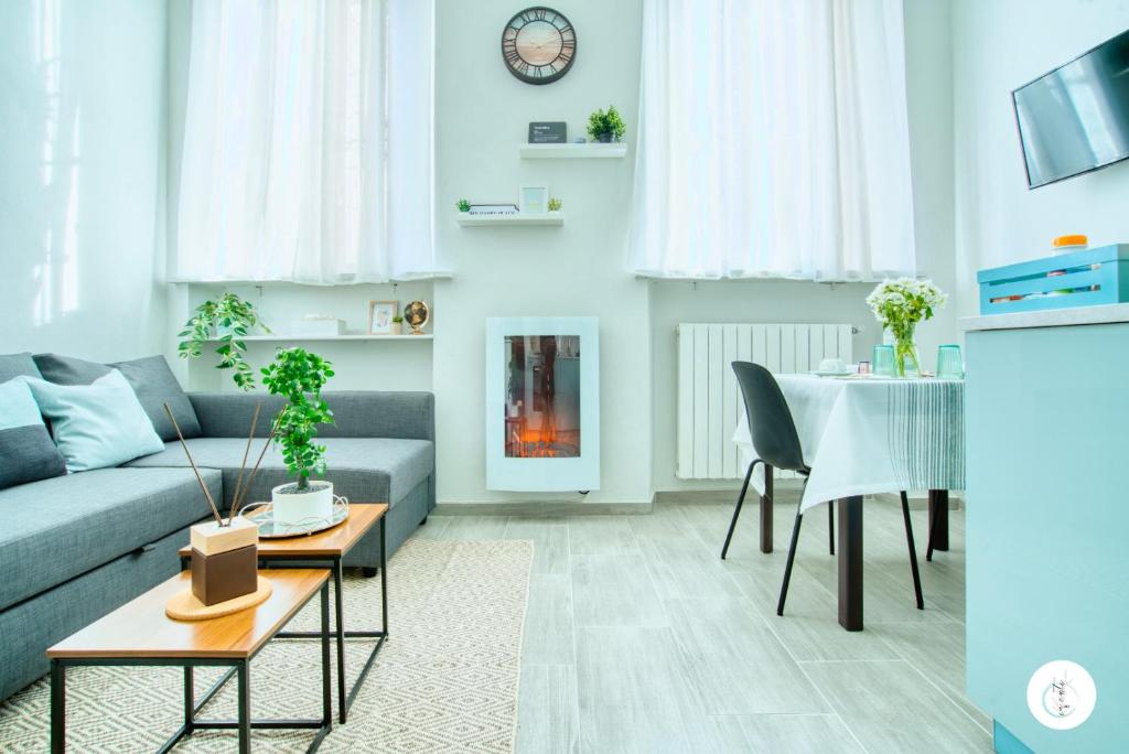 a living room with a couch and a table at In Curti 1913 in Parabiago
