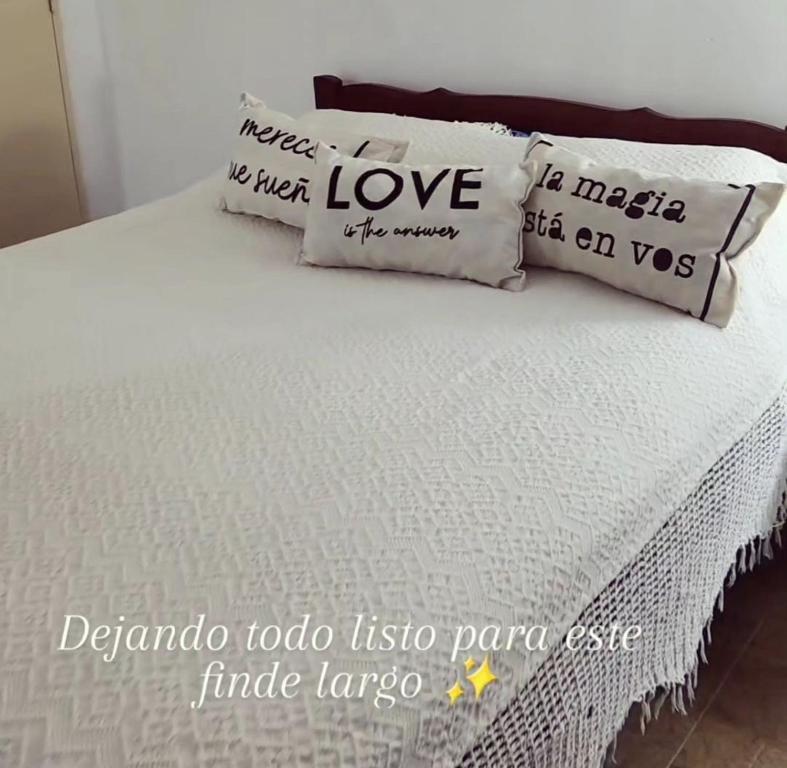 a bed with two pillows on top of it at Departamento Lo de Martha in Mar del Plata