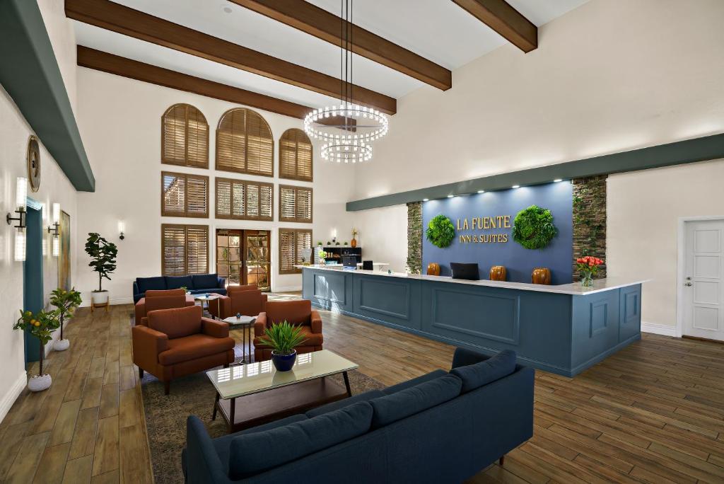 a lobby with couches and a waiting room at La Fuente Inn & Suites in Yuma