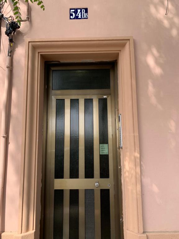 a door with a sign on the side of a building at Habitación en Planta Baja con terraza in Barcelona
