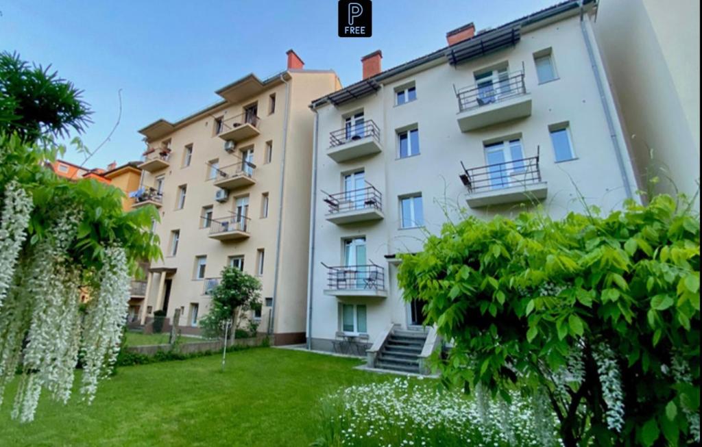 an apartment in a building with a green yard at Boennium Apartments Green Oasis in Ljubljana